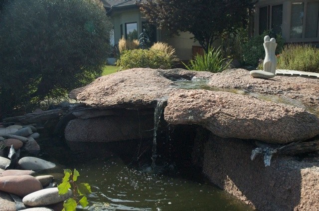 Spouting Rock Spilling into a Pond
