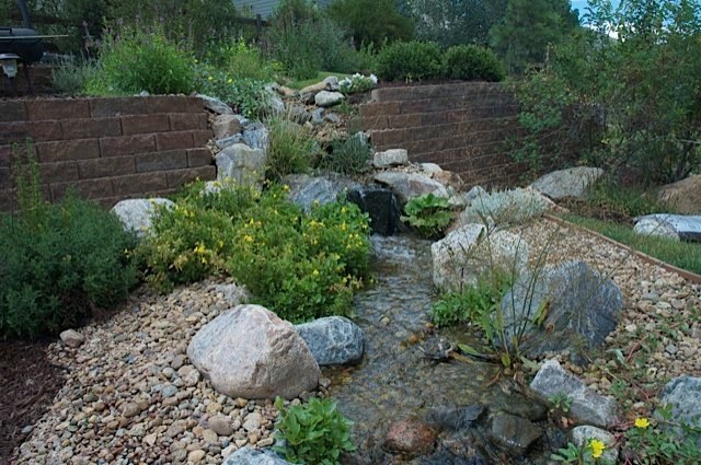 This stream meanders down a beautiful backyard for over 75 feet. The homeowners can sit in various places along the stream to enjoy pools and small ponds and it finally cascades in to a pond with turtles and fish. — at Golden, CO.