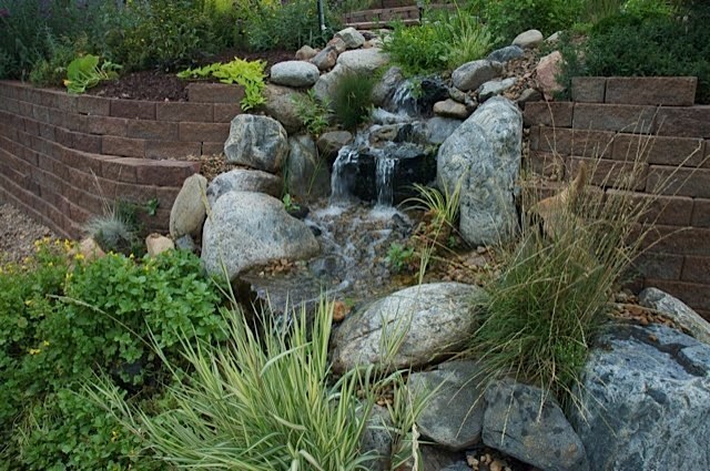 This stream meanders down a beautiful backyard for over 75 feet. The homeowners can sit in various places along the stream to enjoy pools and small ponds and it finally cascades in to a pond with turtles and fish. — at Golden, CO.