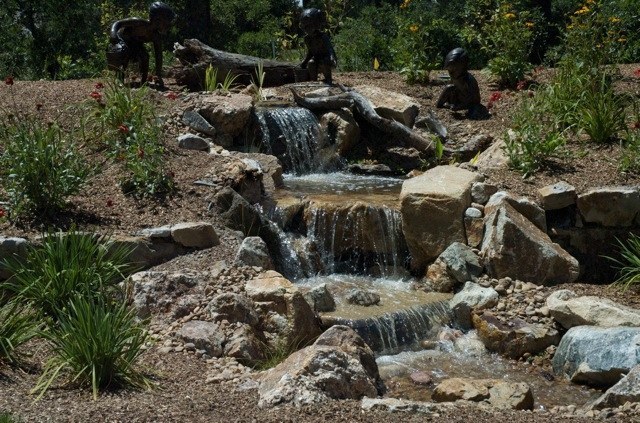 A Castle Pines, Colorado pondless waterfall is the perfect showcase for these bronze sculptures.
